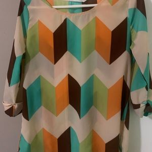 Multi colored geometric blouse with 3/4 length sleeve’s.